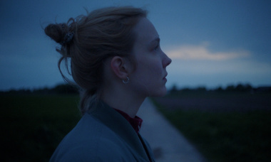 SECHSWOCHENAMT STILL Eine Frau steht auf einem Weg und schaut in die Ferne.